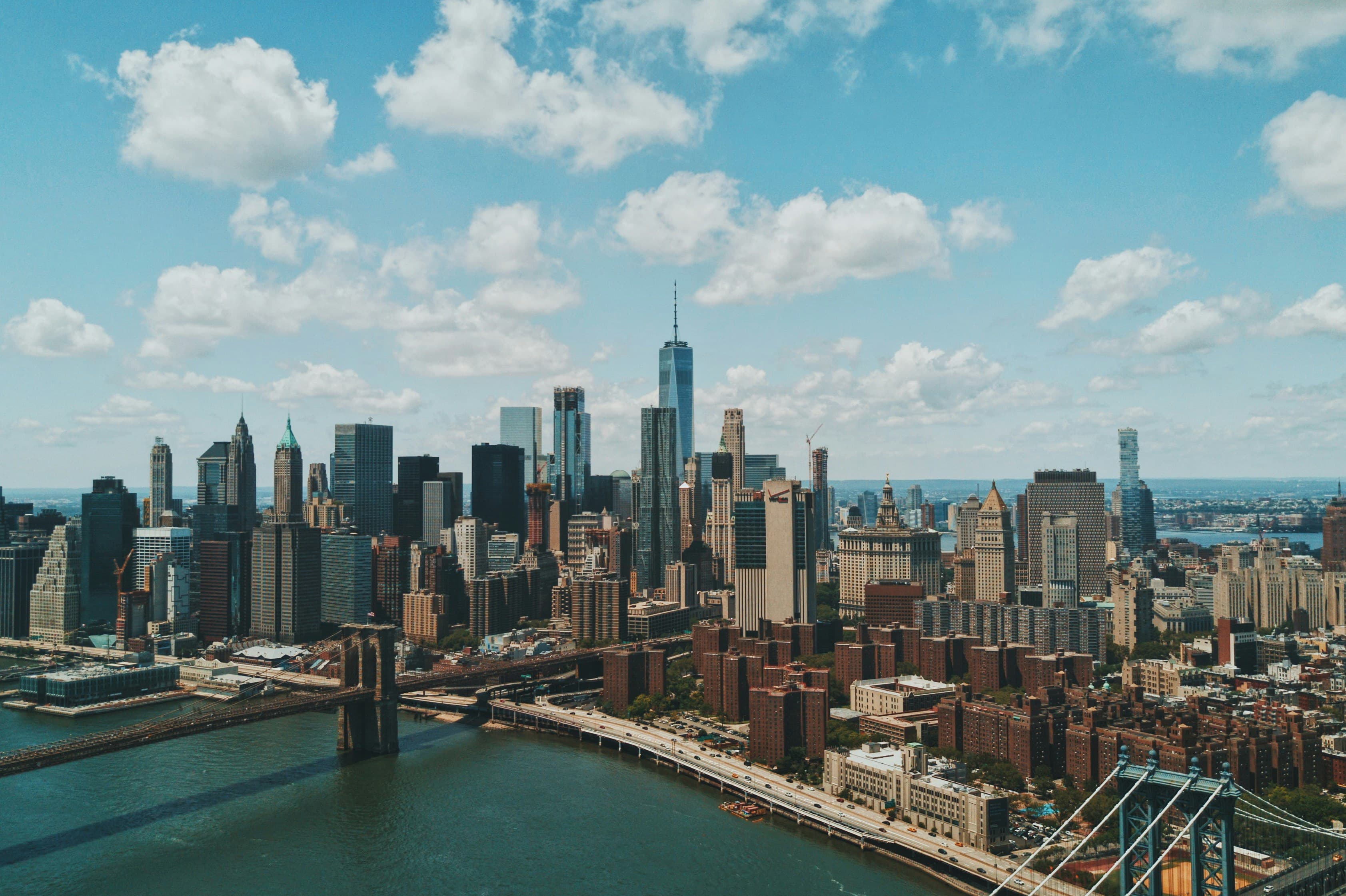 Lower Manhattan skyline and the Brooklyn Bridge over the East River on a sunny day