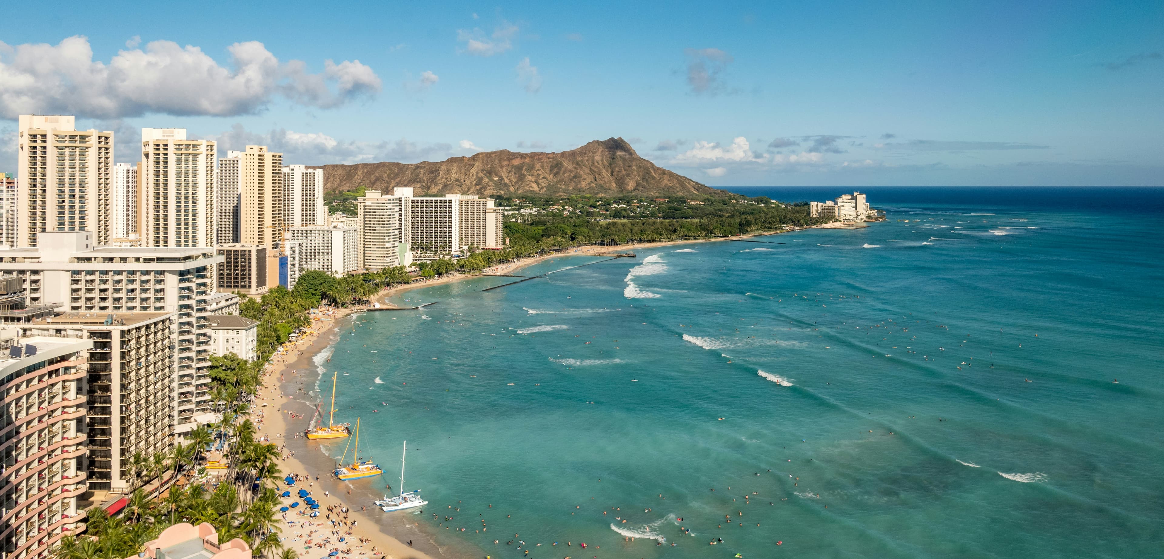 Waikiki Beach hotels and turquoise surf with Diamond Head in the background