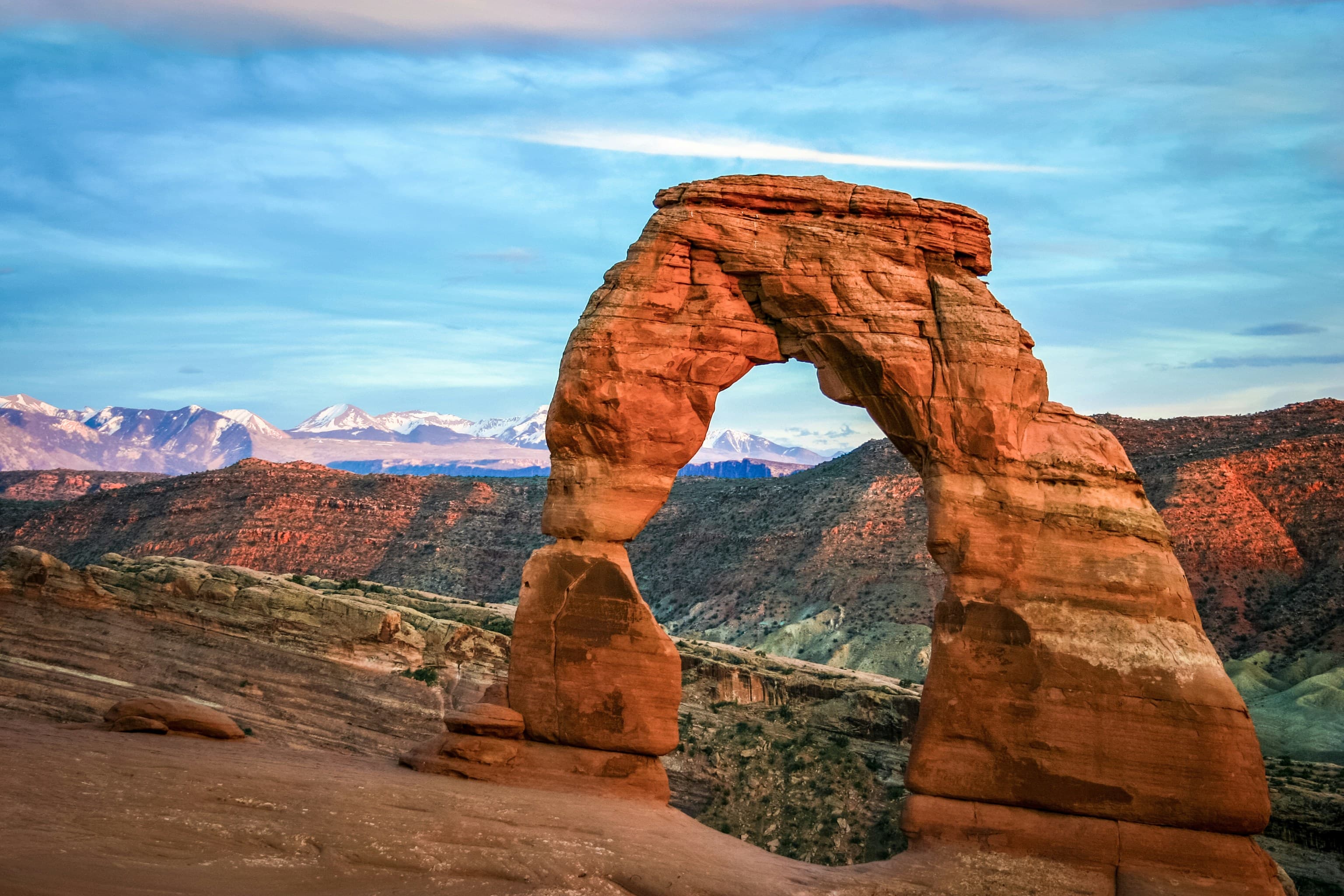 Delicate Arch in Arches National Park, Utah, with the snow-capped La Sal Mountains behind it