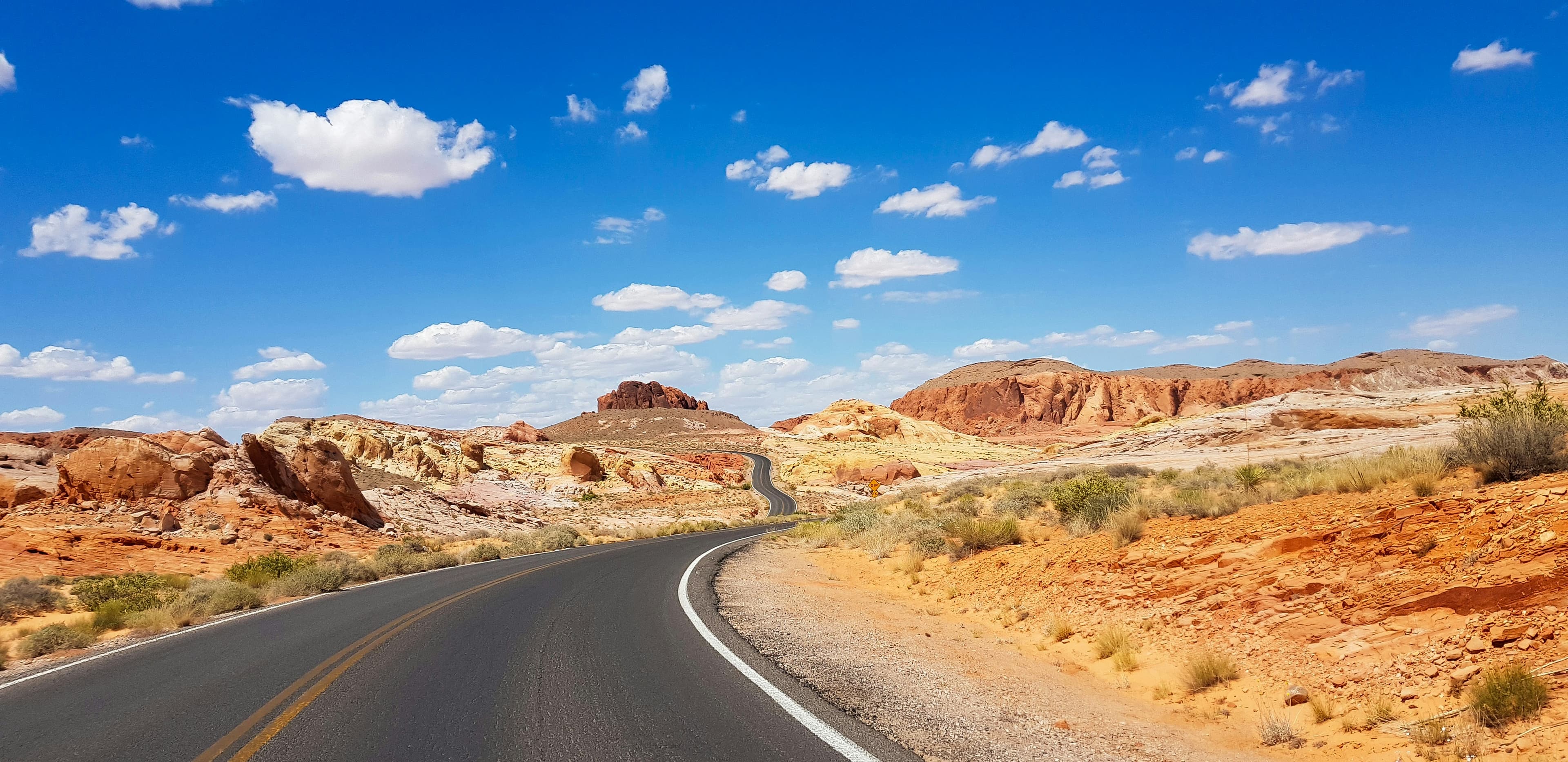 Road winding between red sandstone formations in Valley of Fire State Park, Nevada