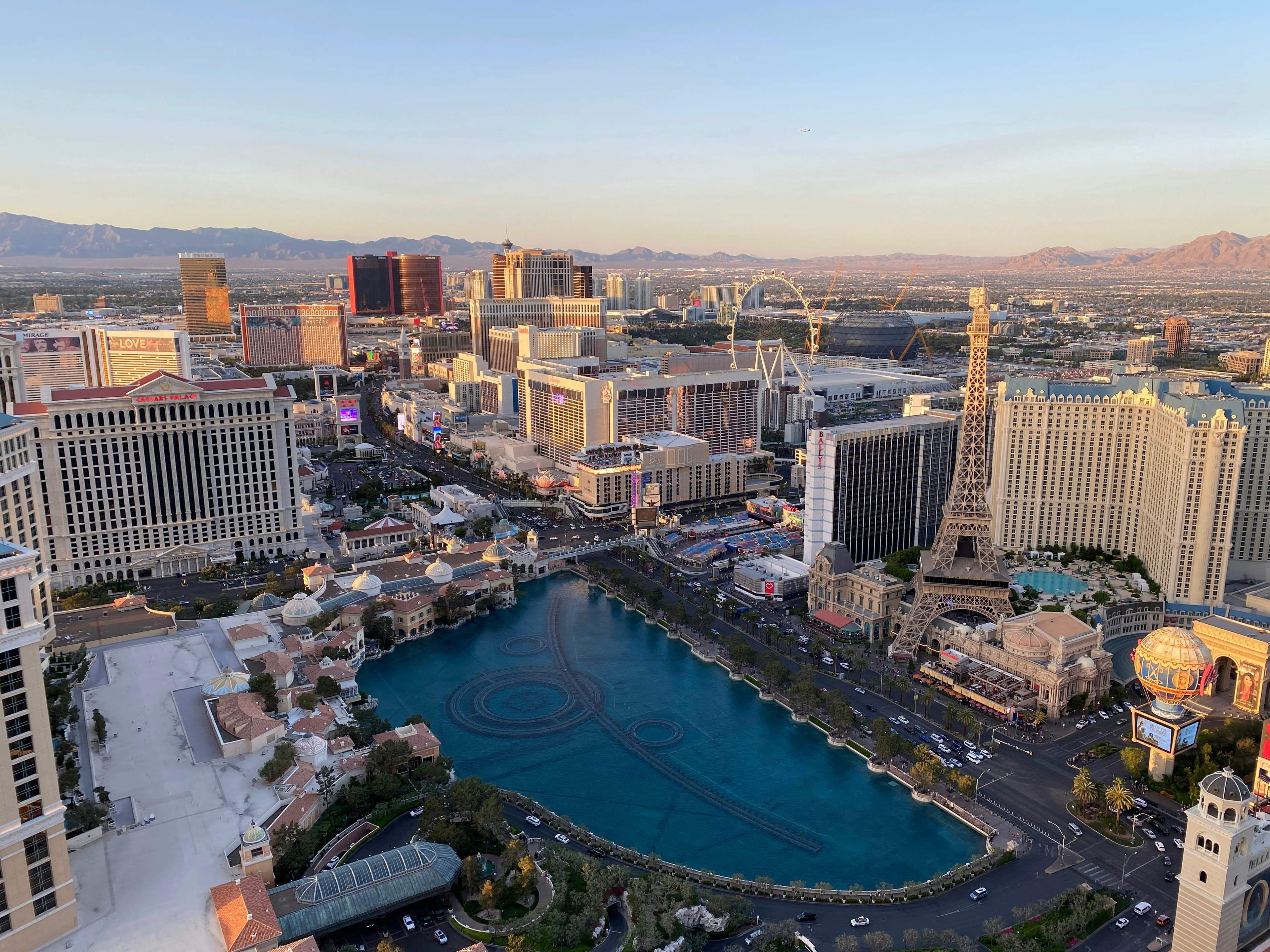 Las Vegas Strip at golden hour with the Bellagio fountain lake and Paris Eiffel Tower