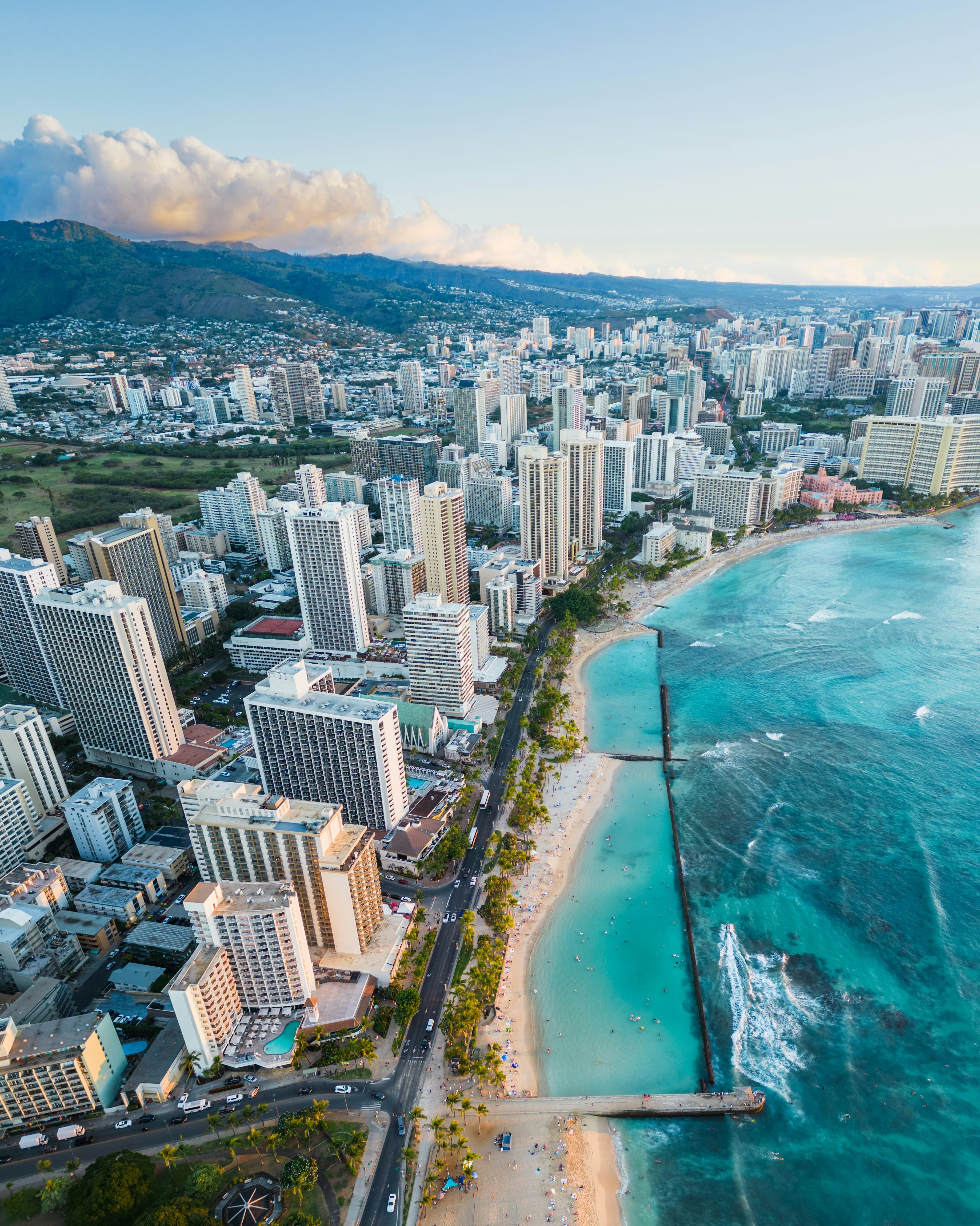 Aerial view of Waikiki high-rises and the Honolulu shoreline at sunset