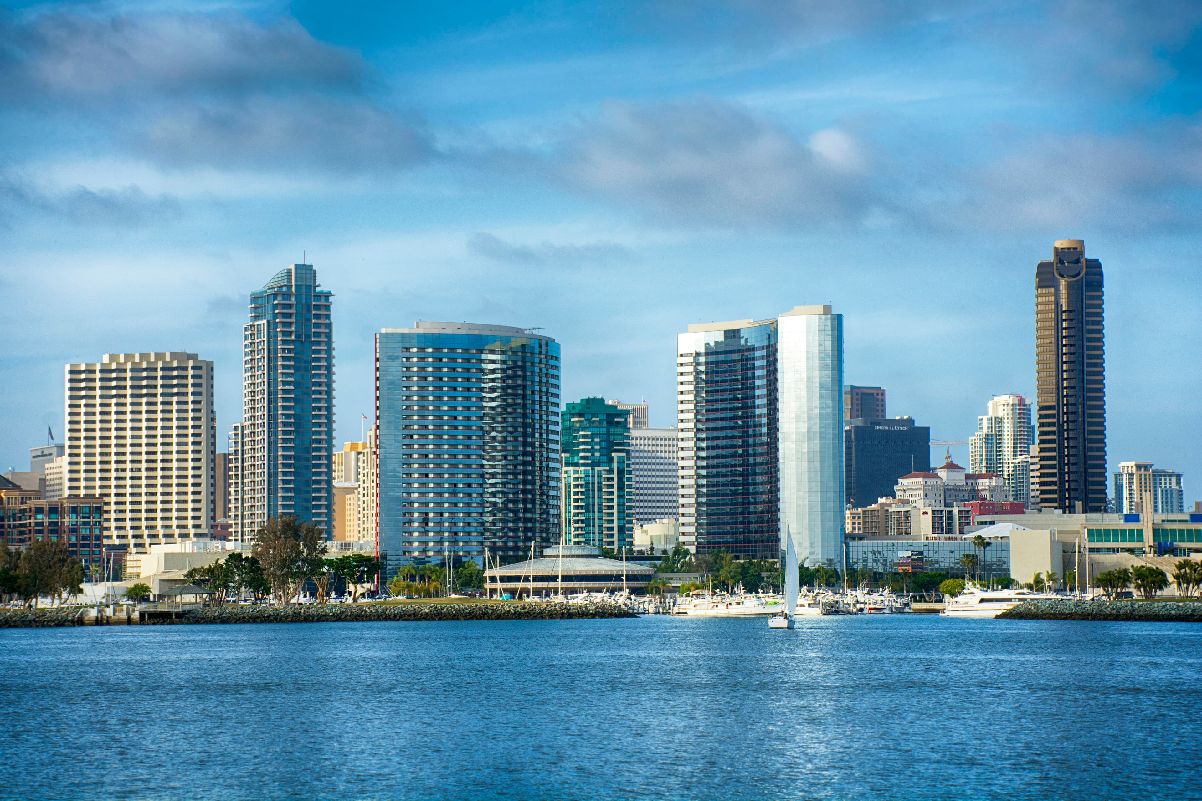 San Diego downtown skyline across the bay with boats on blue water